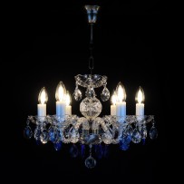 Malý lustr vyrobený z matného kovu a safírově modrých ověsů